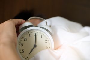 Photo of person holding alarm clock by Acharaporn Kamornboonyarush on Pexels